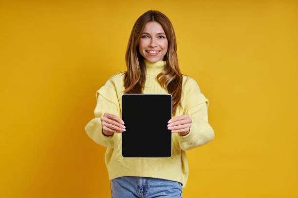 istock Happy young woman showing her digital tablet 1400144180