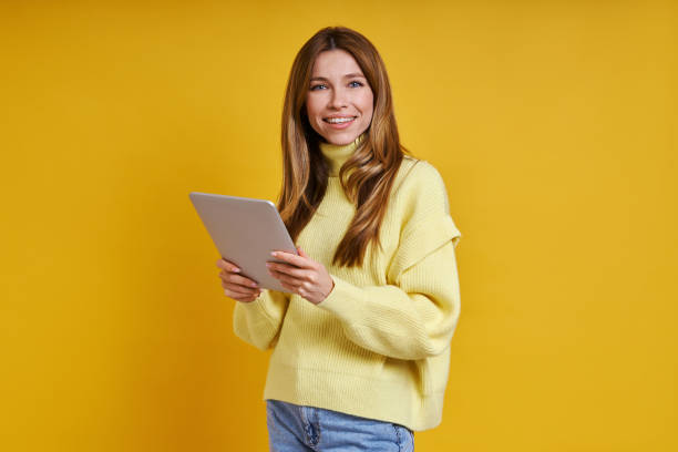 istock Happy young woman holding digital tablet 1400144193