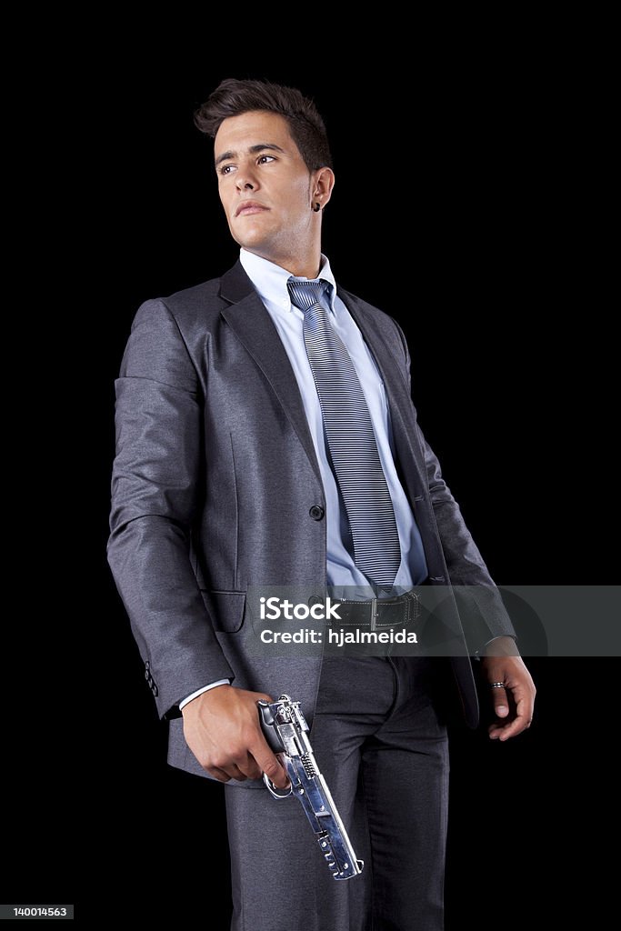 Uomo d'affari che tiene una pistola - Foto stock royalty-free di Arma da fuoco