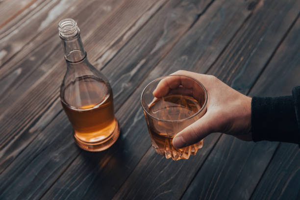 istock men holding a glass of whiskey 1400145863