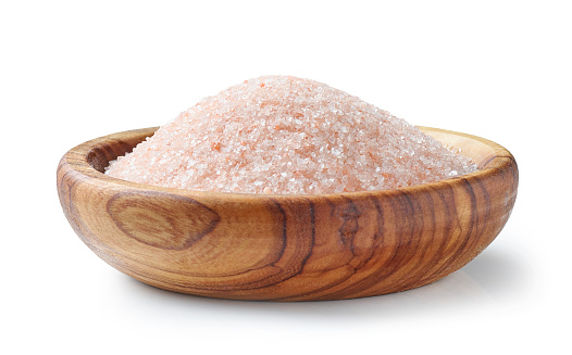 pink himalaya salt in olive wood bowl isolated on white background