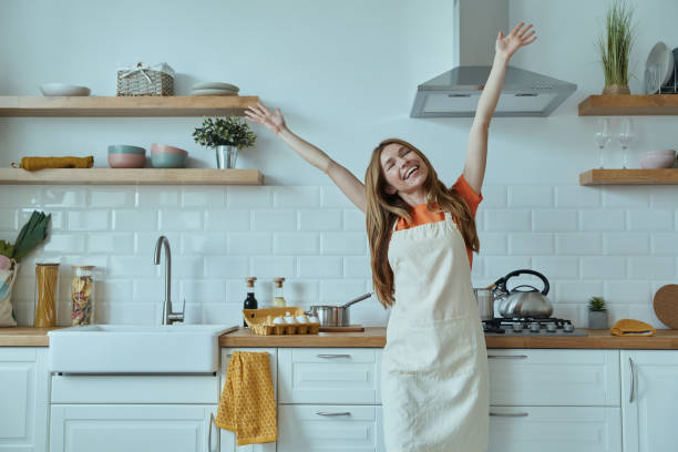 istock Beautiful young woman in apron looking happy 1400148204