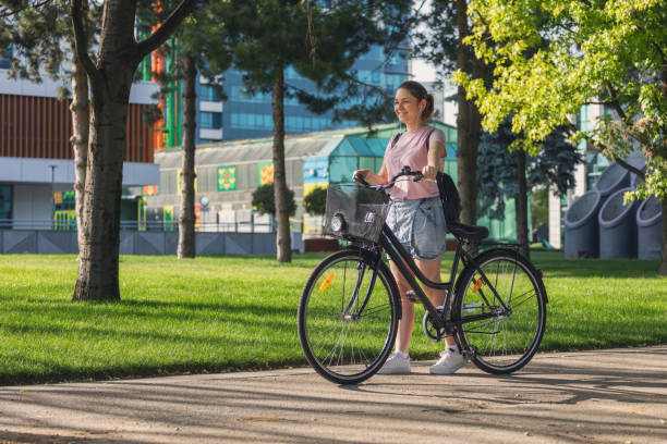 istock Beautiful young girl using bicycle in the city 1400149014