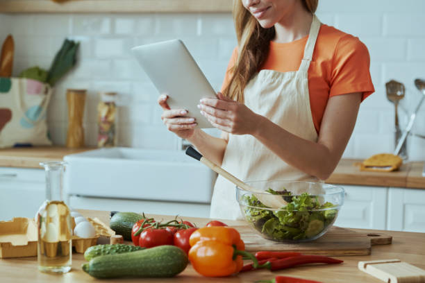 istock Close-up of confident woman using digital tablet 1400149019