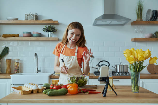 istock Attractive young woman cooking and vlogging 1400149023