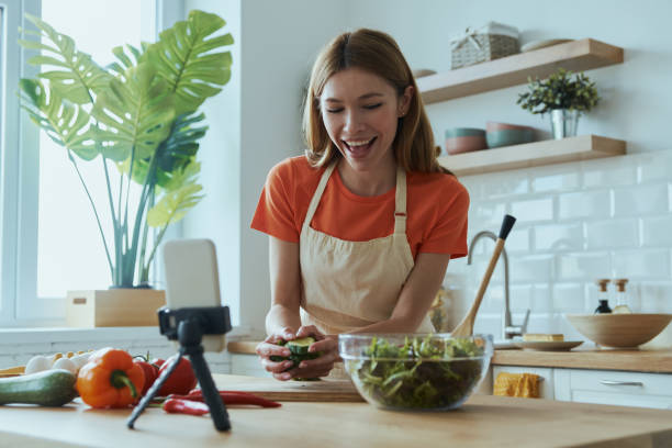 istock Attractive young woman cooking and vlogging 1400149038