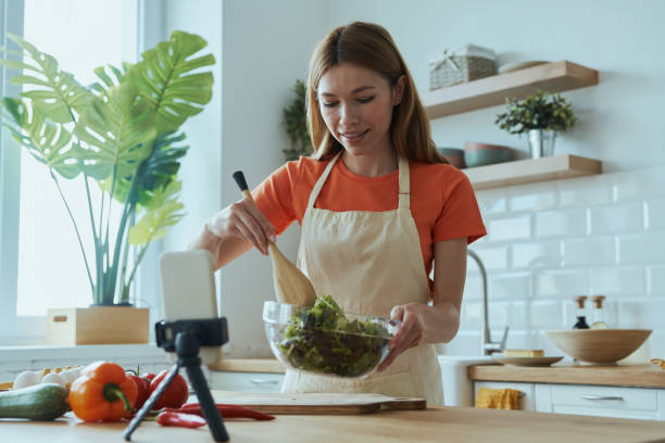 istock Attractive young woman cooking and vlogging 1400149045
