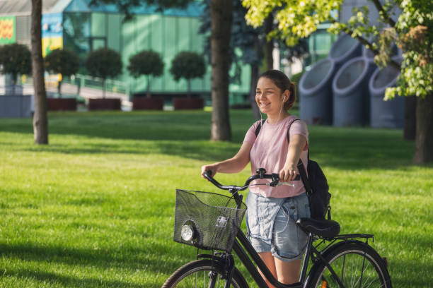istock Beautiful young girl using bicycle in the city 1400149055