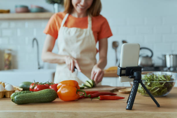 istock Young woman cooking and vlogging 1400149062
