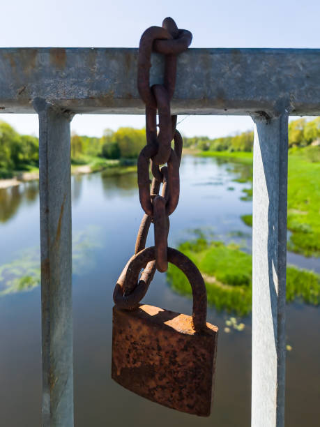 istock Rustic love lock attached for love wishes in a bridge. 1400149063