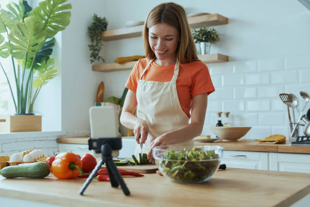 istock Beautiful young woman cooking and vlogging 1400149064