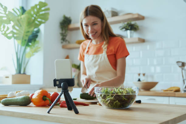 istock Beautiful young woman cooking and vlogging 1400149067