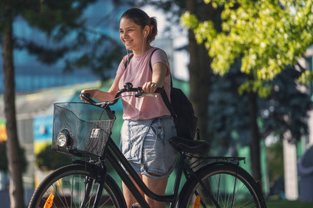 istock Beautiful young girl using bicycle in the city 1400149086