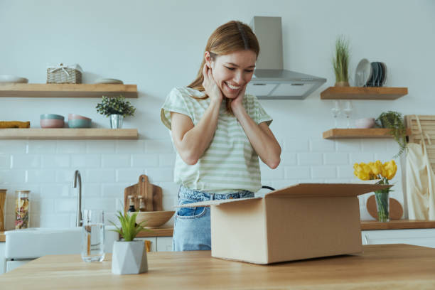 istock Surprised young woman unpacking box 1400149100