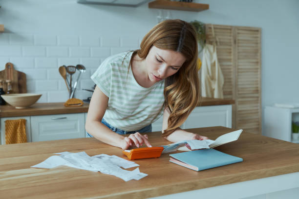 istock Attractive young woman calculating finances 1400149146