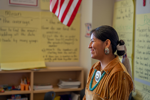 Smiling Young Indigenous Navajo Woman Teacher at the Front of Her Classroom Engaging and Teaching Her Young Students in Monument Valley Utah