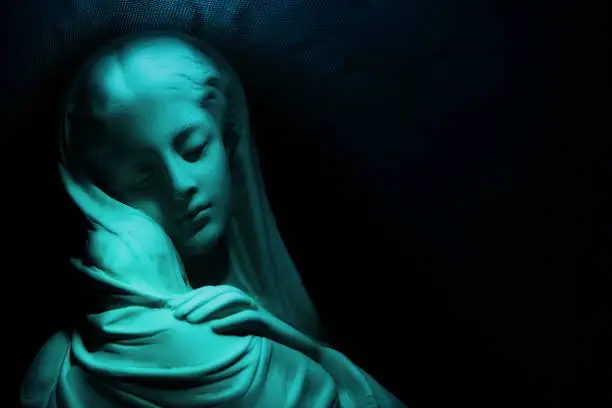 Virgin Mary in blue with dark background