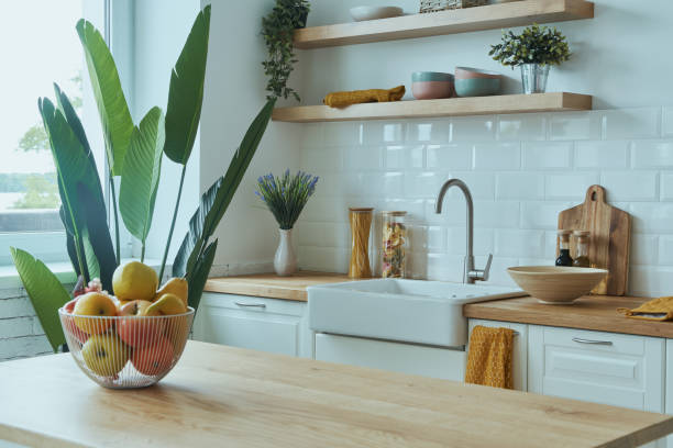 istock Cozy modern interior of kitchen interior with white furniture and bright elements 1400149850