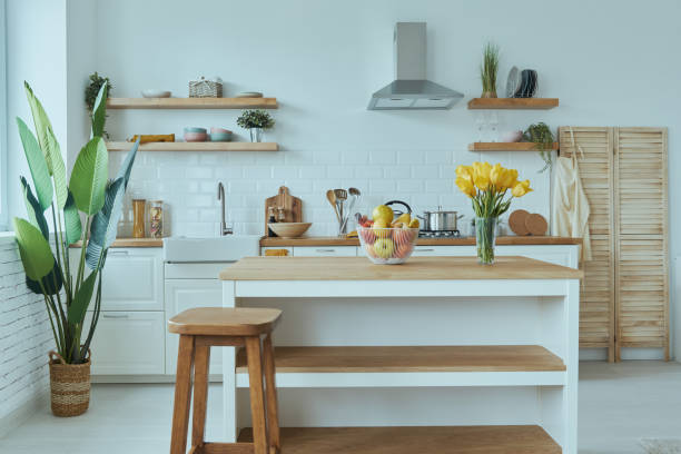 istock Cozy modern interior of kitchen interior with white furniture and bright elements 1400149856