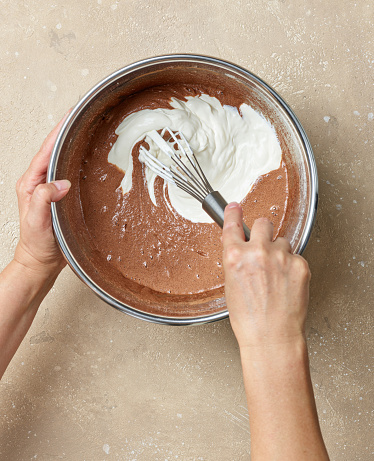 chocolate cake dough making process, mixing yogurt into the dough, top view