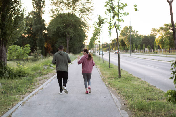 istock Two friends are running together 1400151795