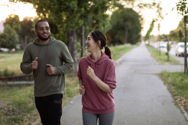 istock Two friends are running together 1400151863