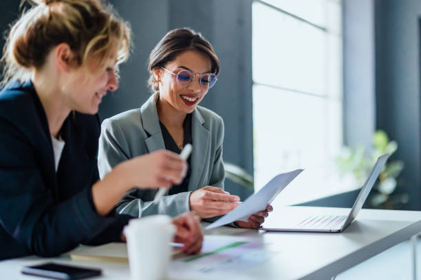 istock Two Business Woman Working Together On A New Project 1400152793