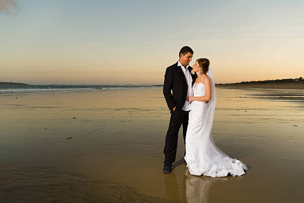 istock Newlyweds on a deserted beach at sunset 140015302