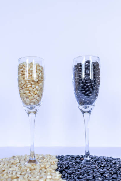 corn and beans grains inside wine glasses , global food crisis concept - healthy eating freight transportation globe planet imagens e fotografias de stock