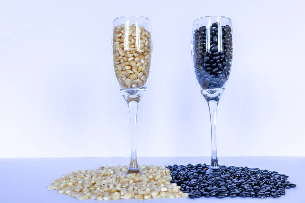 corn and beans grains inside wine glasses , global food crisis concept - healthy eating freight transportation globe planet imagens e fotografias de stock
