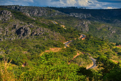 A winding mountain road on the rocky landscape of the Serra do Espinhaço range, between the towns of Serro and Diamantina, Minas Gerais state, Brazil