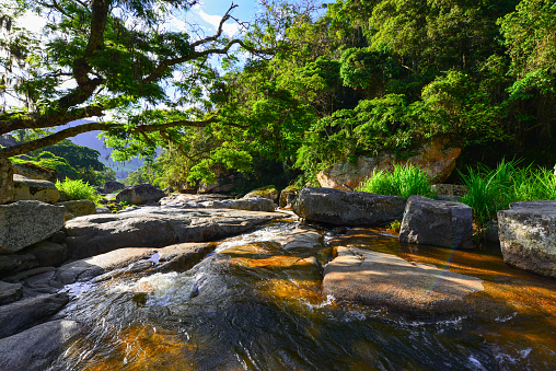 Idyllic late afternoon on a crystal clear mountain river in the green and beautiful Vale dos Frades, Teresópolis, Rio de Janeiro State, Brazil
