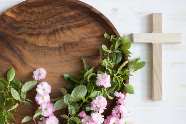istock Wood cross and branches with pink blossoms on teak 1400156345