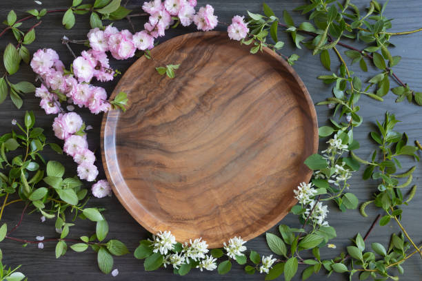 istock Spring blossom frame around teak tray on a dark background 1400156350