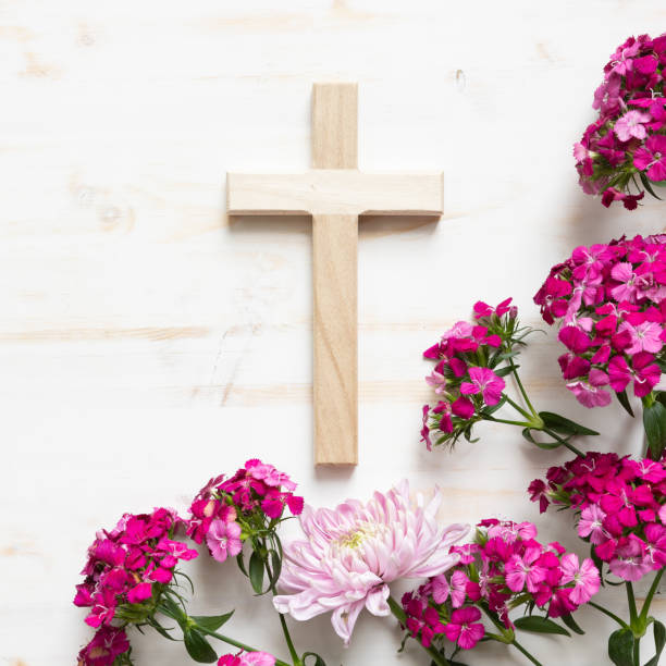 istock Christian cross and pink flowers on white 1400156387