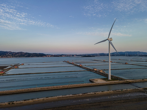 The wind power generation of the marine aquaculture plant at dusk in Fujian,China.