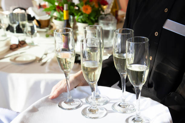 istock waitress holding serving tray with four classes champagne glasses filled with champagne 1400158161