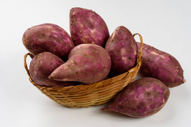 istock Sweet potatoes in a basket isolated on white background. 1400161181