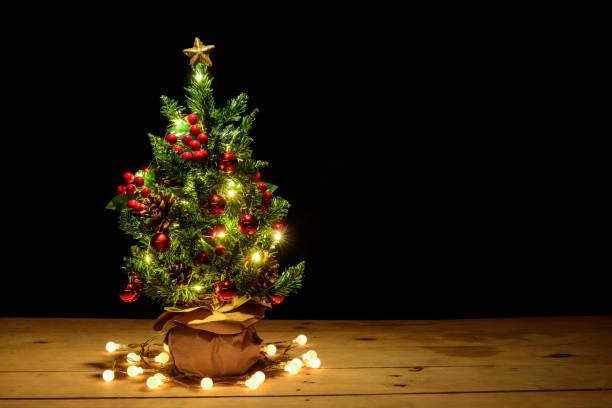 istock Christmas tree on wooden table with black background. 1400161326