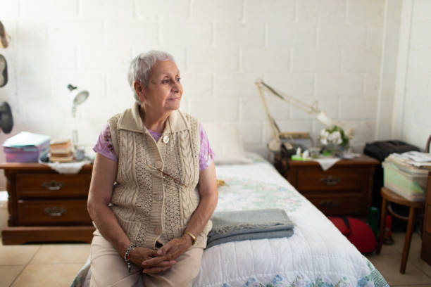 istock Senior woman in her modest home with neutral expression 1400162810