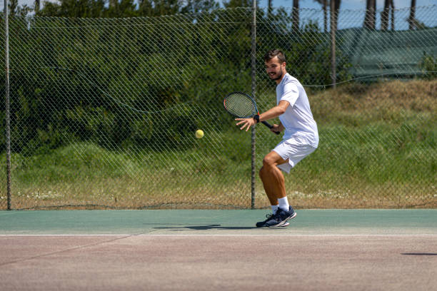 istock Tennis player hitting forehand at ball 1400163629