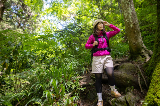 istock Woman climing mountain 1400164347