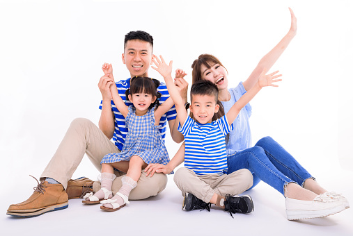 Happy asian family looking at camera and  sitting on white background