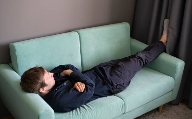 istock young guy lying and sleeping on the sofa at home in the afternoon 1400168054