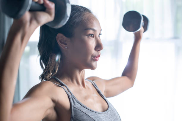 istock Woman doing dumbbell workout at home. 1400170804
