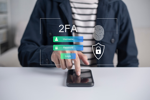 Businessman using smartphone to fingerprint scan for two-factor authentication for safety use of social networks and access to information privacy