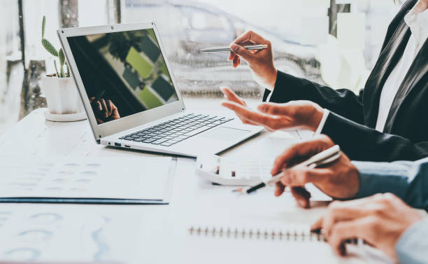 istock Business team hands working with document at working with plan on office desk, blank screen laptop. 1400176489