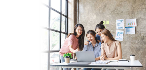 istock Four business women sharing ideas on work strategy by looking at data on laptop computer - Teamwork concept. 1400177188