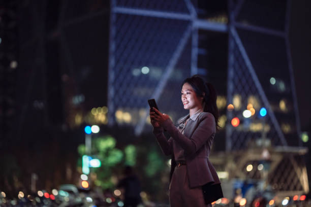 istock Young businesswoman using smartphone in financial district, 1400181782