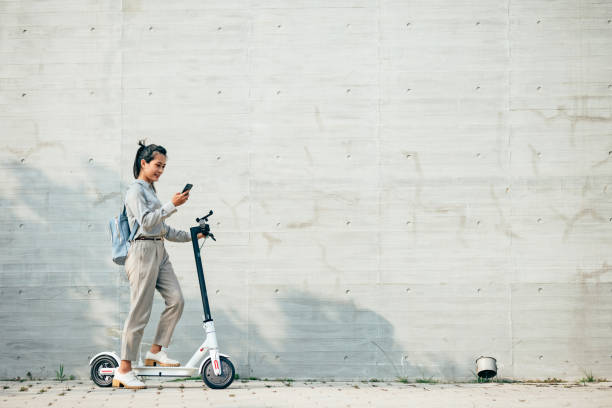istock young woman commuting on rideshare electric scooter 1400181898